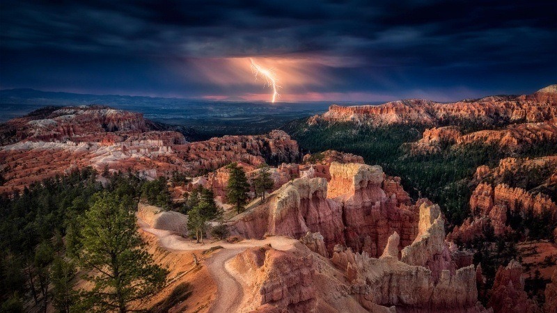 photo orage éclaire canyon terre ocre forêt conifère sapin ciel sombre montagne