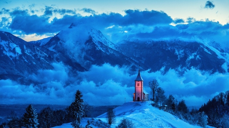 Fond ecran HD paysage hiver montagne Slovénie chapelle sur colline enneigée temps nuageux wallpaper photo image